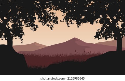Beautiful mountain view from the village at dusk with fantastic trees silhouette