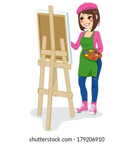 Beautiful painter artist woman holding palette and painting on canvas on easel