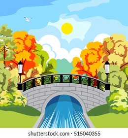 Beautiful park in the fall. Trees with red and yellow foliage. Rapid River. Beautiful antique bridge and cast-iron fence. The black wrought-iron lanterns at the bridge.  bridge reflected in the river.