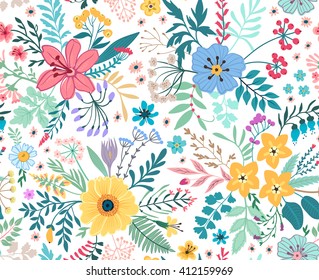 Beautiful pattern in small abstract flower. Small colorful flowers. White background. Spring floral background. The elegant the template for fashion prints.