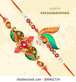 Beautiful peacock feathers decorated rakhi on beige background for the occasion of Raksha Bandhan celebrations. 