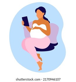 Beautiful pregnant woman communicates via video call on a tablet laptop. Prenatal Consultations online. Pregnancy woman siting on the bed, hand rests on stomach.