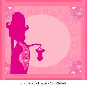 Beautiful pregnant woman on shopping for her new baby- abstract background