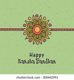 Beautiful rakhi design on grungy green background for Indian festival, Raksha Bandhan celebration.
