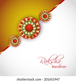 Beautiful rakhi on grey and brown background on the occasion of Happy Raksha Bandhan festival.  