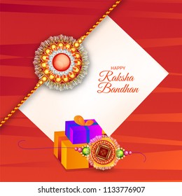 Beautiful rakhi (wristband) and gift boxes decorated on red texture background for Raksha Bandhan concept.