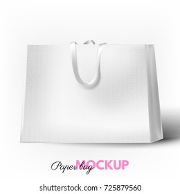 Beautiful, realistic, white paper shopping bag mockup with white silk handle and texture