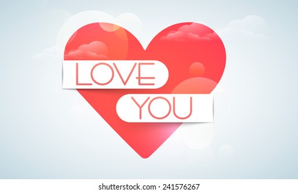 Beautiful red heart covered by love you ribbon for Happy Valentine's Day celebration on cloudy blue background.