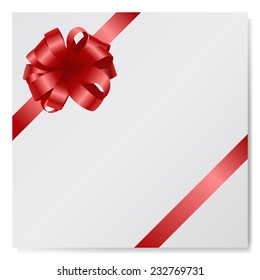Beautiful red silk bow on empty paper card isolated on white background