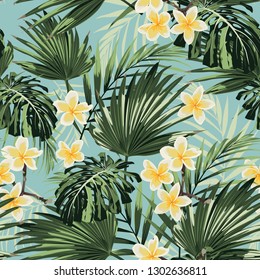 Beautiful seamless floral pattern background with exotic bright palm leaves and plumeria flowers. Perfect for wallpapers, web page backgrounds, textile. Vintage blue background.