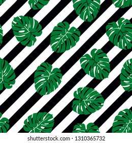Beautiful seamless pattern with green tropical leaf on a black stripes background, trendy fashion textile print, pop art design. Retro 80s style.