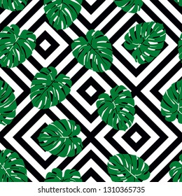 Beautiful seamless pattern with green tropical leaf on geometric background, trendy fashion textile print, pop art design. Retro 80s style.