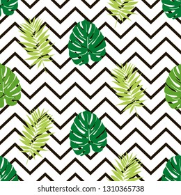 Beautiful seamless pattern with green tropical leaf on a black zig zag background, trendy fashion textile print, pop art design. Retro 80s style.