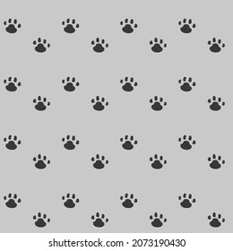 Hermoso patrón impecable con huellas de pata. Muestra las huellas en un fondo gris. Ilustración del vector