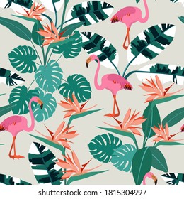 Beautiful seamless vector floral exotic pattern with tropical flowers, palm leaves, jungle plants, bird of paradise flower, pink flamingos. Hawaiian background for textile, packaging.