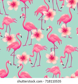 Beautiful seamless vector tropical pattern with pink flamingo and flowers on blue background. Abstract summer texture