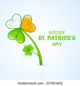 Beautiful shamrock leaf in Irish Flag colors on blue background for Happy St. Patrick's Day celebration.