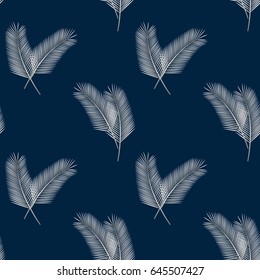 Beautiful silver palm leaves on a blue background. Tropical plants seamless pattern for your design. Vector illustration.