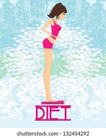 beautiful slim brunette checking her weight on scales