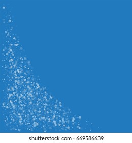 Beautiful snowfall. Bottom left corner on blue background. Vector illustration.