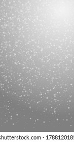 Beautiful snowfall Christmas background. Subtle flying snow flakes and stars on grey background. Appealing winter silver snowflake overlay template. Ravishing vertical illustration.