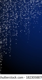 Beautiful snowfall Christmas background. Subtle flying snow flakes and stars on dark blue background. Alluring winter silver snowflake overlay template. Resplendent vertical illustration.
