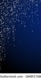 Beautiful snowfall Christmas background. Subtle flying snow flakes and stars on dark blue background. Alive winter silver snowflake overlay template. Immaculate vertical illustration.