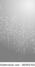 Beautiful snowfall Christmas background. Subtle flying snow flakes and stars on grey background. Alive winter silver snowflake overlay template. Posh vertical illustration.