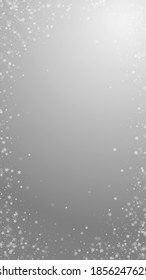 Beautiful snowfall Christmas background. Subtle flying snow flakes and stars on grey background. Actual winter silver snowflake overlay template. Outstanding vertical illustration.