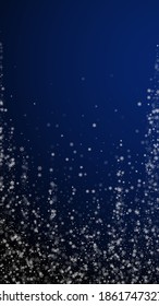 Beautiful snowfall Christmas background. Subtle flying snow flakes and stars on dark blue background. Alluring winter silver snowflake overlay template. Fancy vertical illustration.