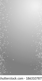 Beautiful snowfall Christmas background. Subtle flying snow flakes and stars on grey background. Adorable winter silver snowflake overlay template. Actual vertical illustration.