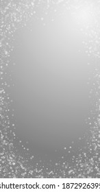 Beautiful snowfall Christmas background. Subtle flying snow flakes and stars on grey background. Actual winter silver snowflake overlay template. Terrific vertical illustration.