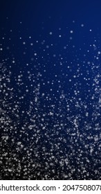 Beautiful snowfall Christmas background. Subtle flying snow flakes and stars on dark blue background. Amazing winter silver snowflake overlay template. Outstanding vertical illustration.