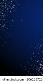 Beautiful snowfall Christmas background. Subtle flying snow flakes and stars on dark blue background. Adorable winter silver snowflake overlay template. Curious vertical illustration.
