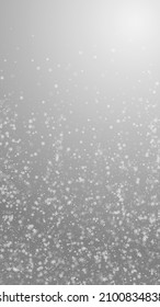 Beautiful snowfall Christmas background. Subtle flying snow flakes and stars on grey background. Amazing winter silver snowflake overlay template. Overwhelming vertical illustration.