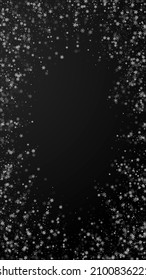 Beautiful snowfall Christmas background. Subtle flying snow flakes and stars on black background. Actual winter silver snowflake overlay template. Good-looking vertical illustration.