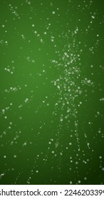 Beautiful snowfall christmas background. Subtle flying snow flakes and stars on christmas green background. Beautiful snowfall overlay template. Vertical vector illustration.