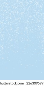 Beautiful snowfall christmas background. Subtle flying snow flakes and stars on light blue winter backdrop. Beautiful snowfall overlay template. Vertical vector illustration.