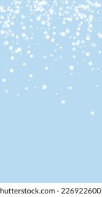 Beautiful snowfall christmas background. Subtle flying snow flakes and stars on light blue winter backdrop. Beautiful snowfall overlay template. Vertical vector illustration.