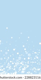 Beautiful snowfall christmas background. Subtle flying snow flakes and stars on light blue winter backdrop. Beautiful snowfall overlay template. Vertical vector illustration.