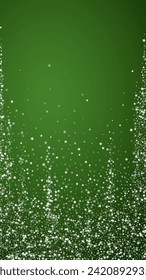 Beautiful snowfall christmas background. Subtle flying snow flakes and stars on christmas green background. Beautiful snowfall overlay template. Vertical vector illustration.