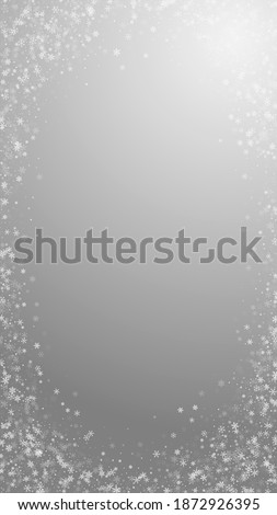 Beautiful snowfall Christmas background. Subtle flying snow flakes and stars on grey background. Actual winter silver snowflake overlay template. Terrific vertical illustration.