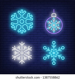 Beautiful snowflakes and Christmas bauble neon signs set. Christmas, winter and New Year Day design. Night bright neon sign, colorful billboard, light banner. Vector illustration in neon style.