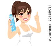 Beautiful sport brunette woman happy smiling showing water bottle and making thumb up sign