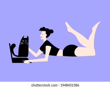 beautiful sports girl on a blue background is in quarantine, working remotely, stroking a black cat and smiling
