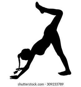 Beautiful sporty girl practices yoga, eka pada adho mukha svanasana, one-legged downward-facing dog pose