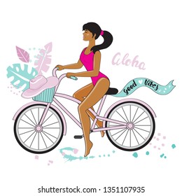 Beautiful summer girl in a bathing suit riding a bike and the inscription good vibes