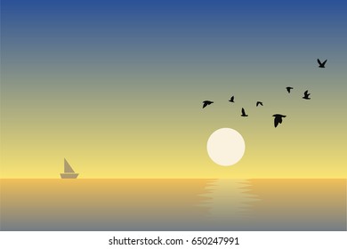 Beautiful sunset and flying birds over the sea surface