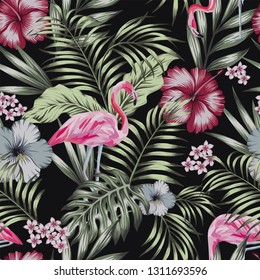 Beautiful tropical bird pink flamingo with flowers hibiscus, plumeria (frangipani) and palm, banana leaves composition. Vector seamless pattern on the black background