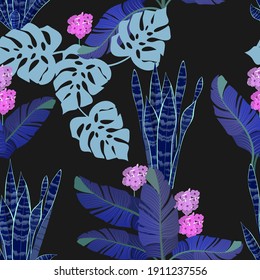 Beautiful tropical leaves and flowers on a black background. Seamless vector illustration. For decorating textiles, packaging, wallpaper.